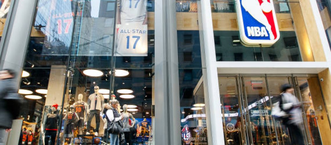 New York, February 21, 2017: People standing and walking by the front window of the NBA store in Manhattan.
